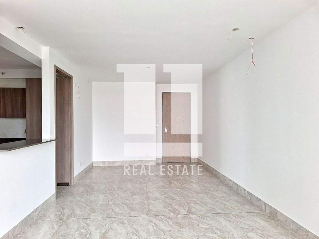 Kitchen with marble-like wall tiles, wood cabinets and black granite countertop in PH Luxor 400 600 Panama City