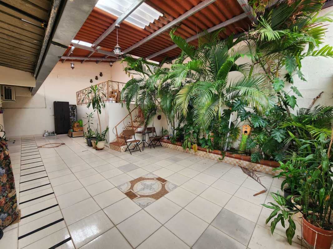 Indoor patio with tiled floors and plants in house Brisas de Santa María Panama