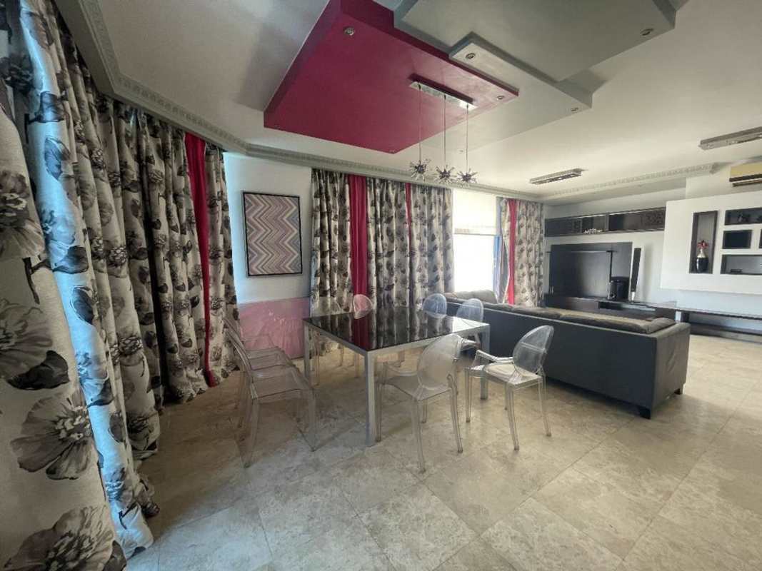 Bright living and dining area with floor-to-ceiling windows showcasing spectacular ocean views at BICSA Tower Panama City