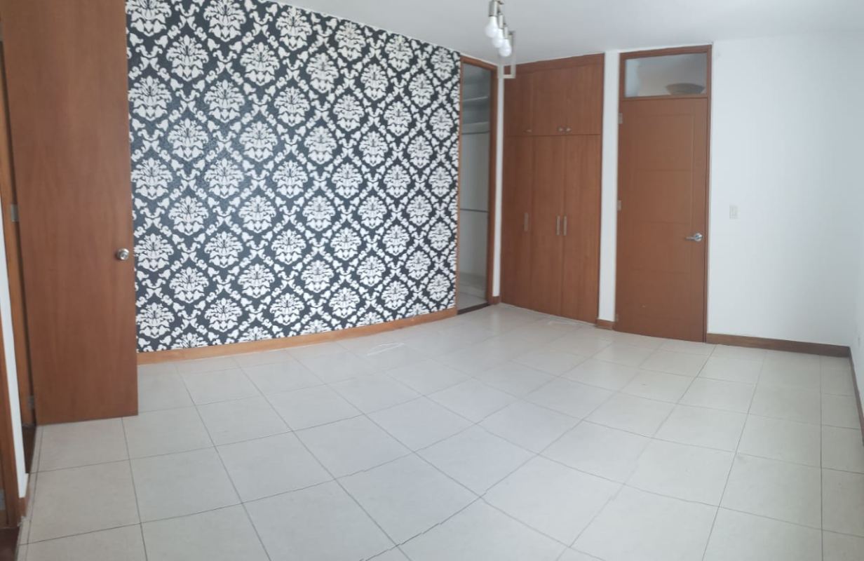 Bedroom with accent wallpaper built-in wardrobe tile floor PH Mont Royale Panama