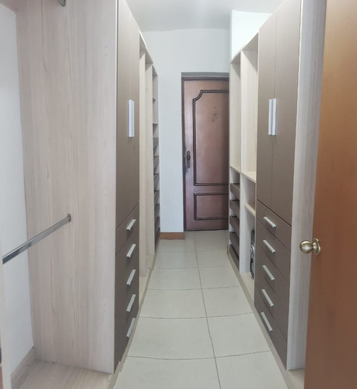 Modern walk-in closet wood cabinetry drawers PH Mont Royale El Cangrejo Panama