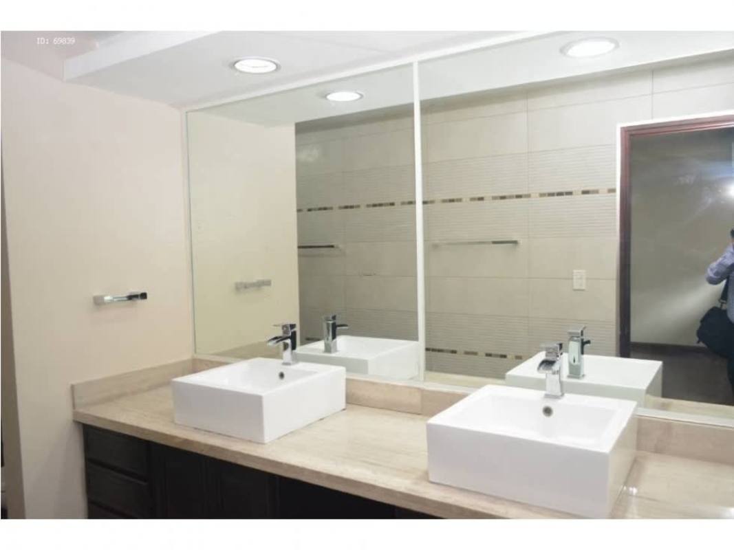 Kitchen with granite countertops white cabinets and appliances in house at Condado del Rey Panama