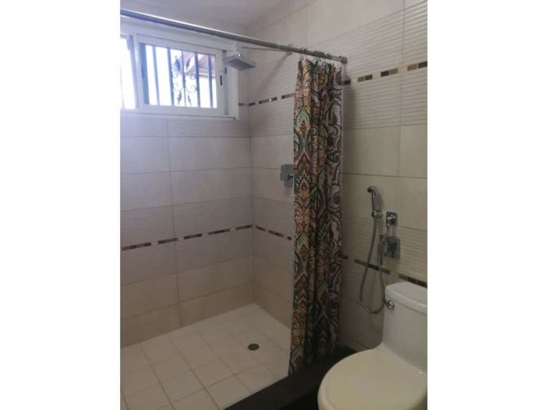 Contemporary bathroom with walk-in shower and decorative curtain in Panama house for sale