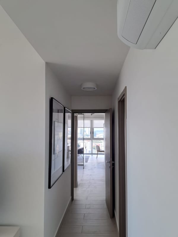 Furnished bedroom with large windows city skyline view PH Urbana Obarrio Panama