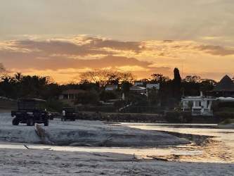 Modern living room opens to covered patio and pool in Punta Barco beach villa Panama