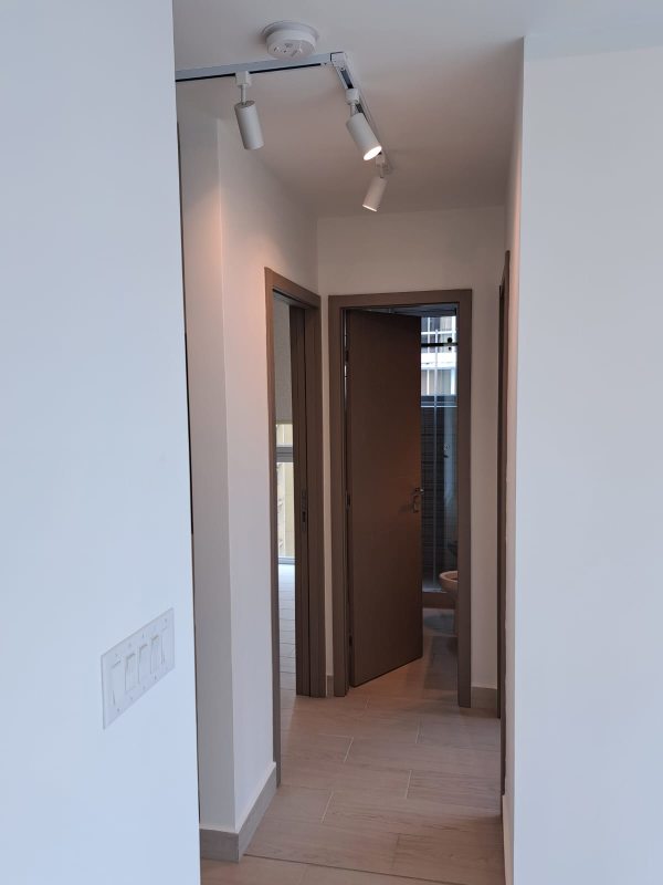 Living area with large windows, sliding doors to balcony at PH Urbana Obarrio Panama City