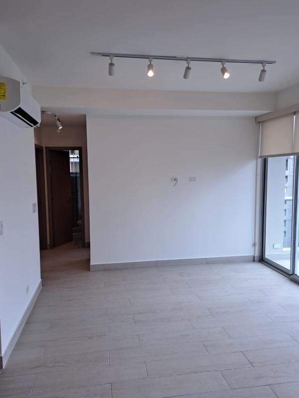 Stacked washer dryer unit inside laundry closet area in PH Urbana apartment Panama City