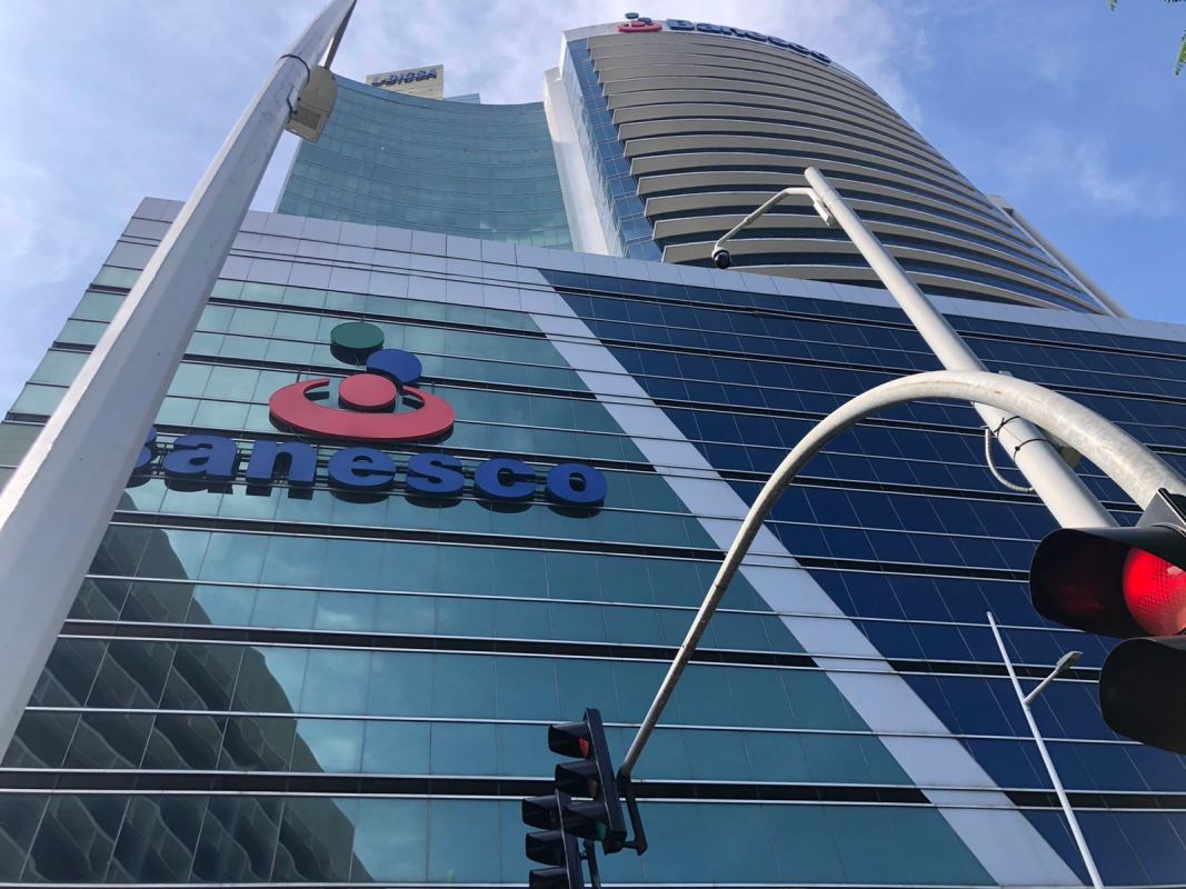 Small break area kitchenette with microwave, mini fridge, wall art inside PH Banesco Tower Panama