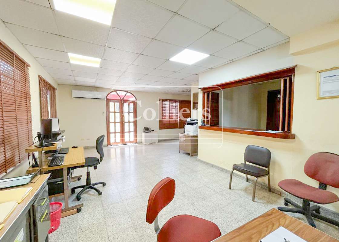 Empty office with tiled floors, drop ceiling, and multiple windows Chanis Panama