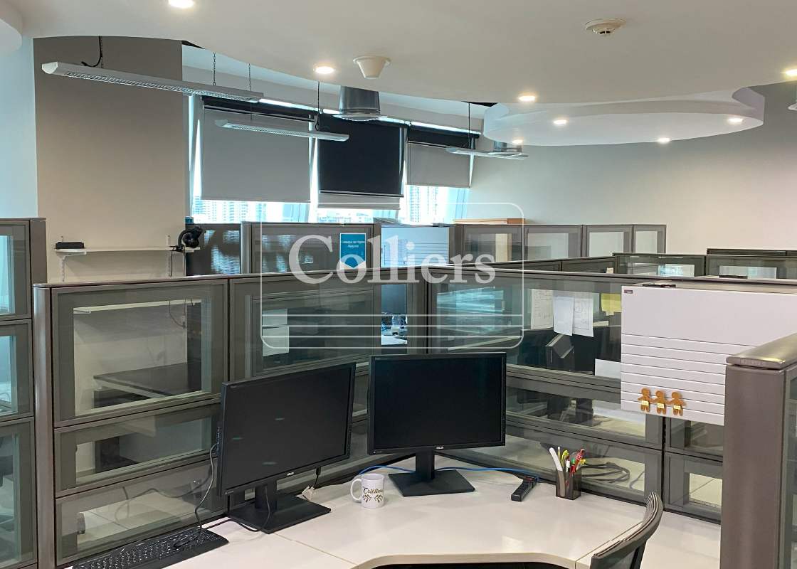 Corporate office cubicle set up with dual monitors near windows in Torre de las Américas Punta Pacífica Panama