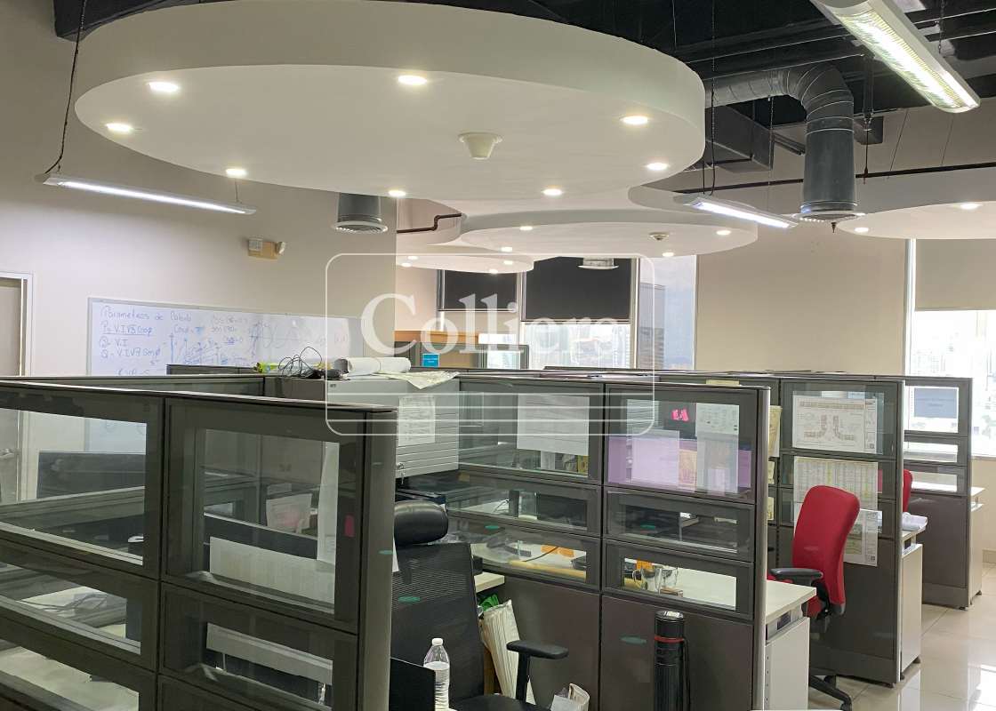 Modern open office plan with cubicles glass partitions in Torre de las Américas business tower Panama City