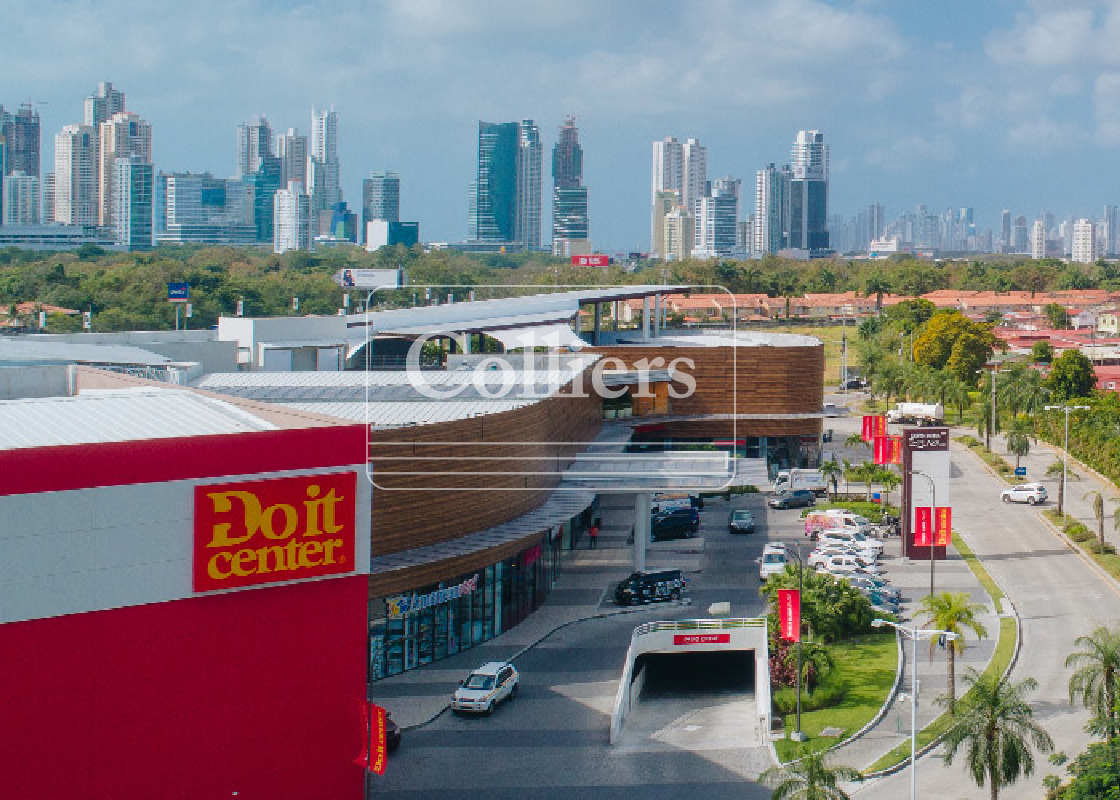 Aerial image of large modern shopping mall with Do it Center anchor store and downtown Panama skyline in distance