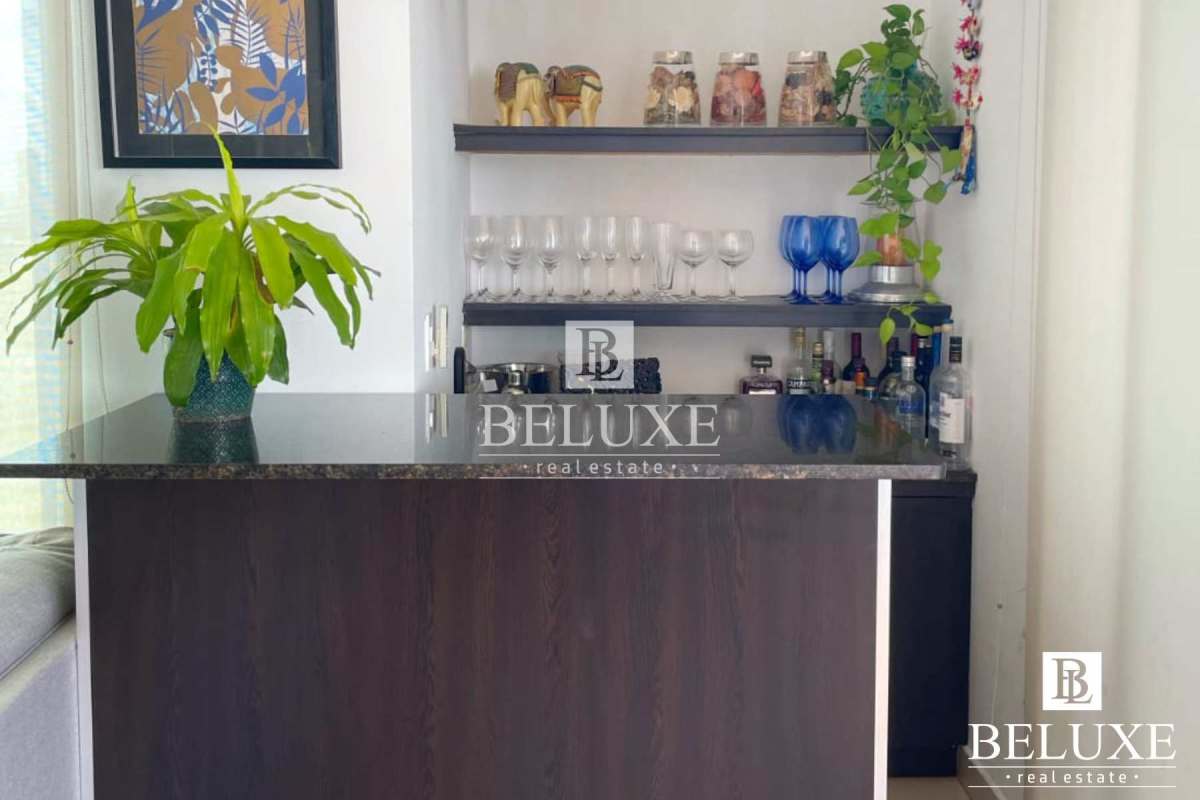 Home bar with granite counter, shelving and decorative accents at PH Concept San Francisco Panama City