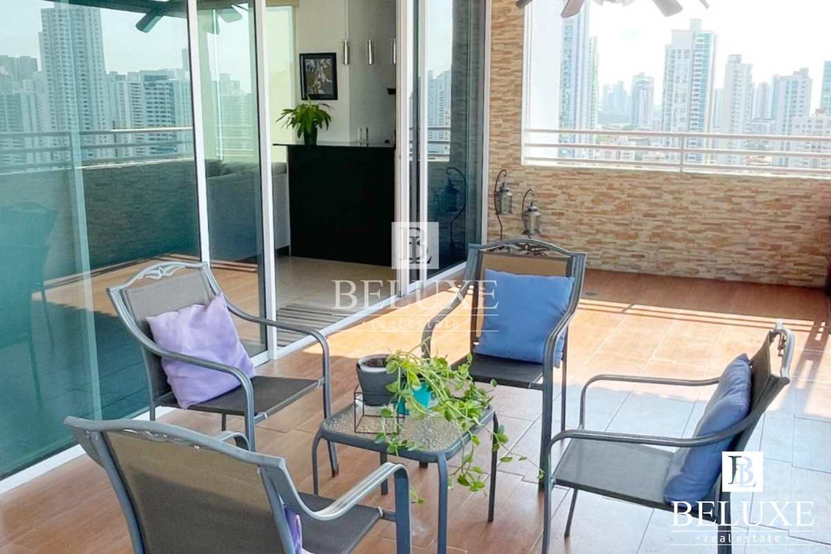 Balcony with panoramic city skyline view, outdoor seating and ceiling fan in PH Concept San Francisco Panama City