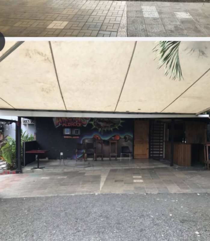 Covered canopy outdoor patio with bar counter graffiti mural tropical plants Albrook Panama