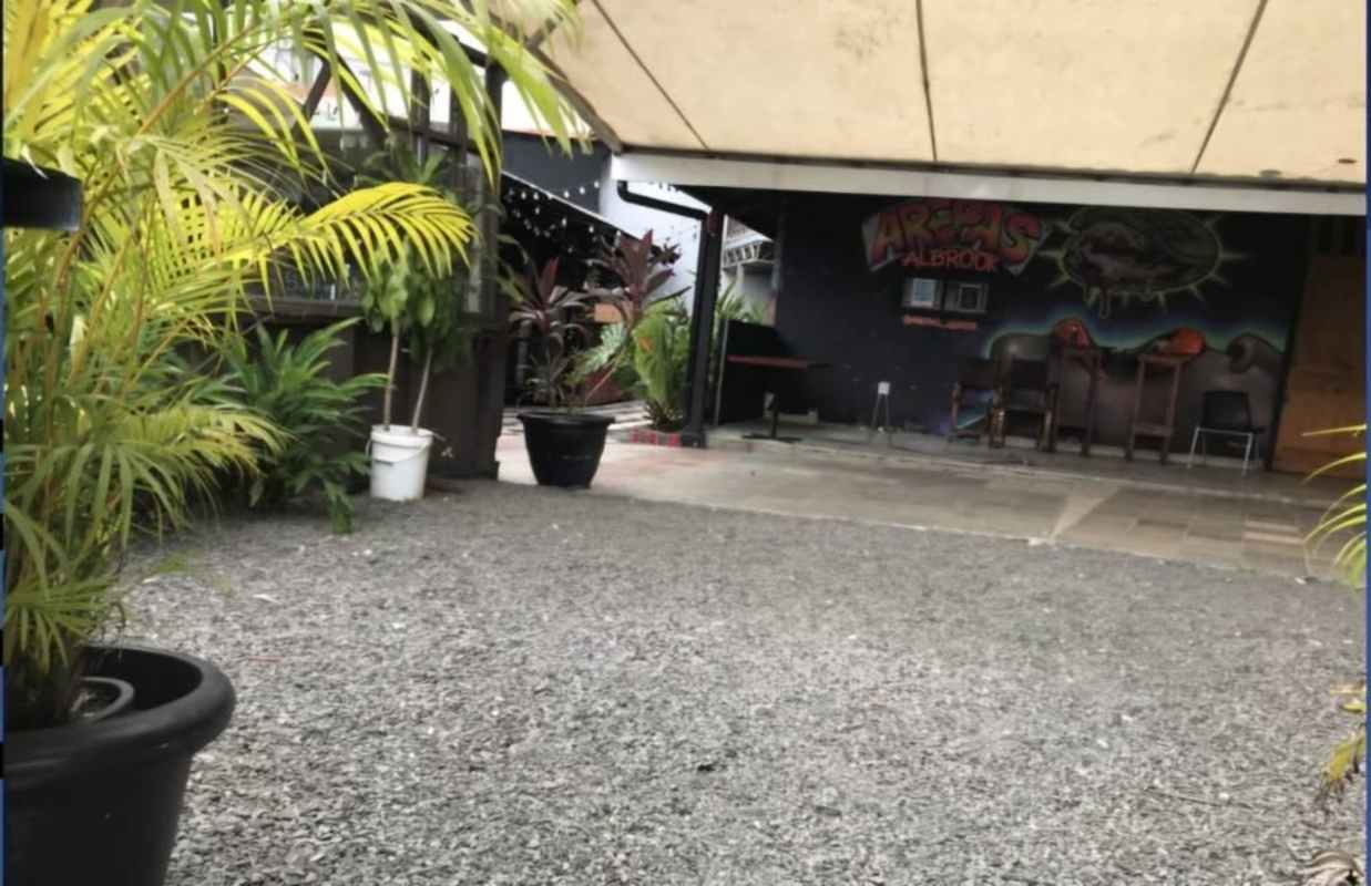 Covered patio with gravel potted plants wall art tropical decor Albrook commercial Panama