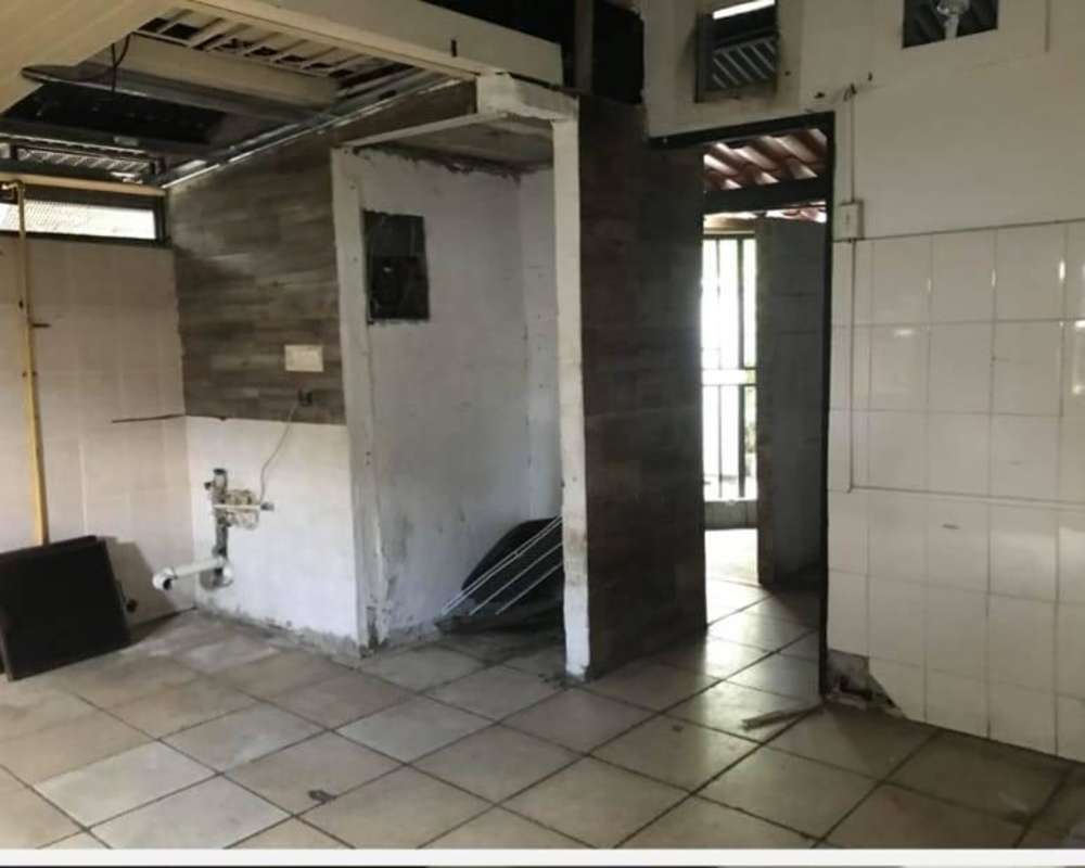 Unfinished kitchen space with plumbing tiles exposed ceiling commercial property Albrook Panama