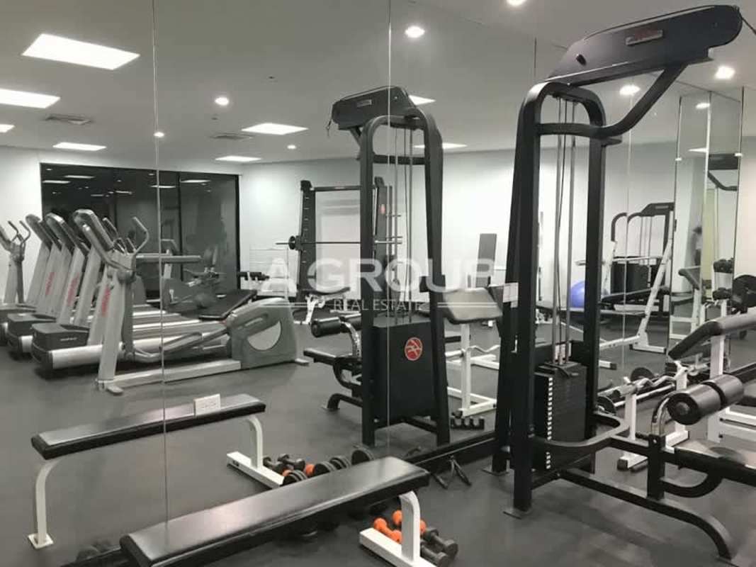 Modern gym with cardio machines, weights, mirrors at Villa Marina Punta Paitilla Panama