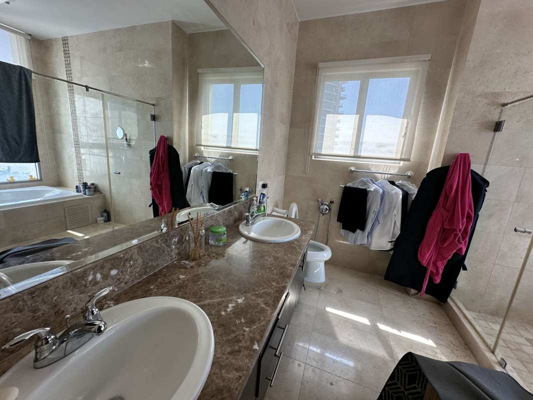 Spacious balcony with glass railings, ceiling fan and Pacific Ocean view in PH Paramount Panama