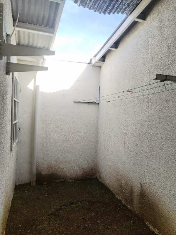 Side utility patio partially covered with clothesline in affordable house Cabra Pacora Panama