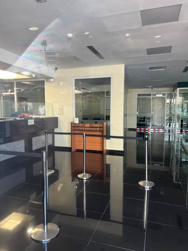 Teller counter area with glass partitions and security features in Panama City commercial bank space