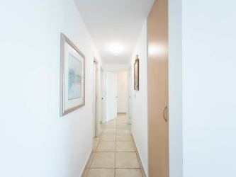 Saltwater lagoon pool surrounded by palm trees and beachfront condos at Playa Blanca Resort Panama