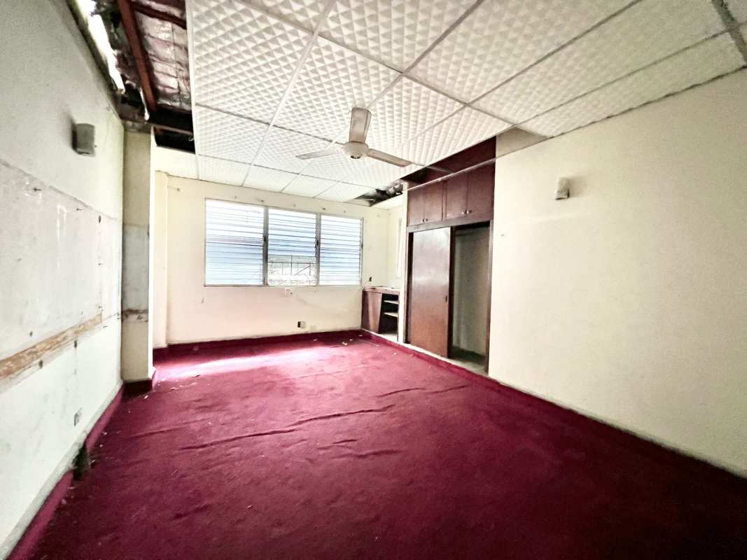 Spacious living room area with tile floors and ceiling fan for sale Altos del Golf Panama