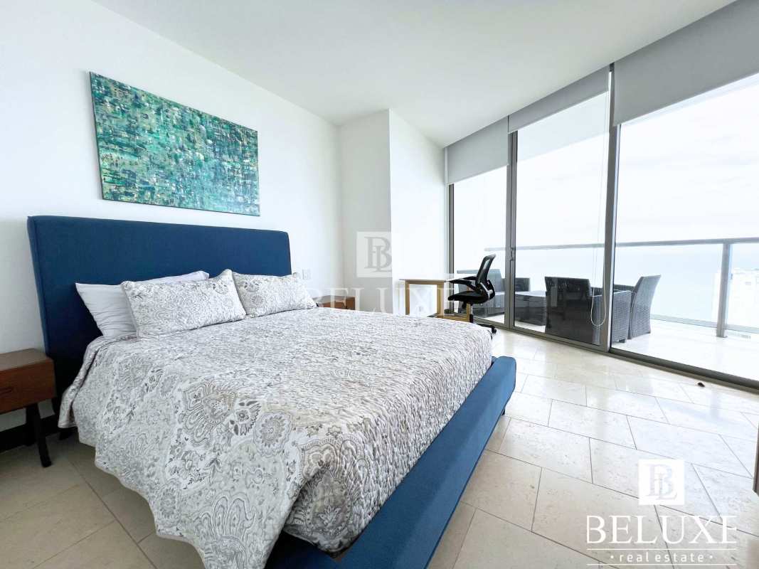 Elegant living room with large windows balcony access and city ocean views at Trump Ocean Club Panama