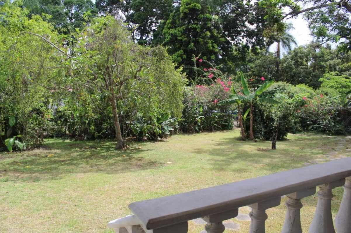 Bright living room with leather armchairs white sofa dartboard colonial house Las Cumbres Panama