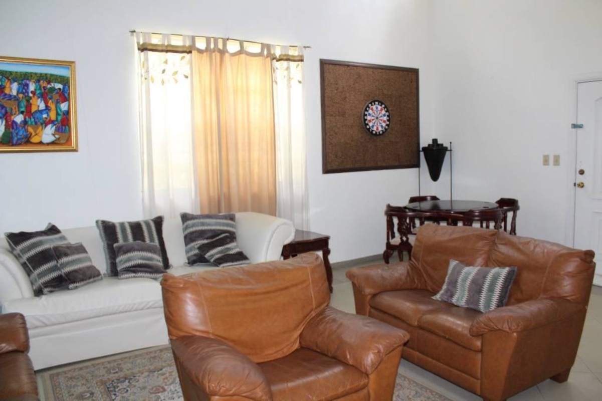 Colorful living dining space turquoise walls sofas dining set air conditioning Las Cumbres Panama