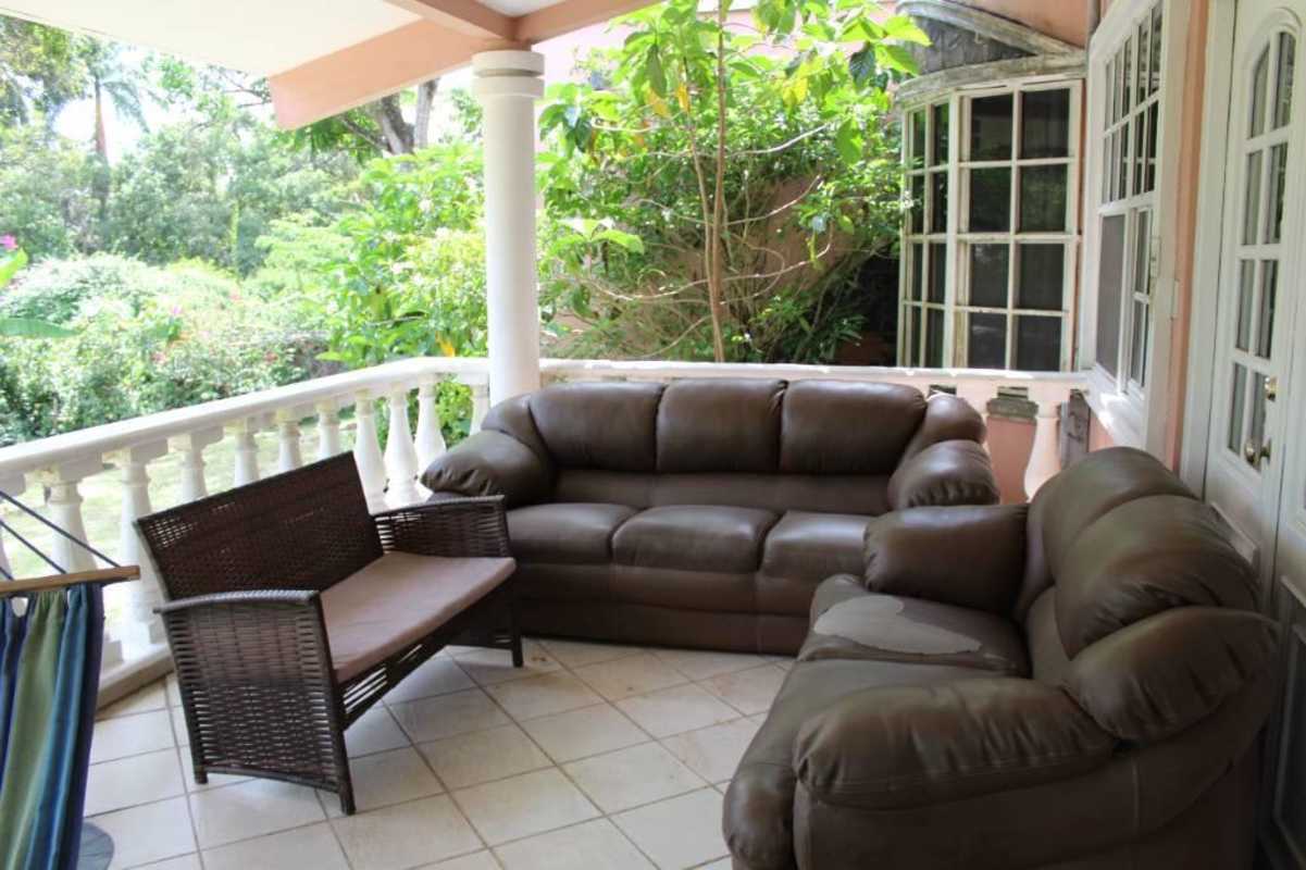Verdant backyard garden with tropical plants trees flowering bushes fenced yard Las Cumbres Panama