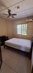 Bedroom with split AC, ceiling fan, closet, tiled floor in La Fontana Residences