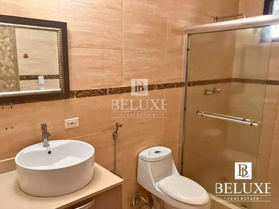 Bathroom with vessel sink, wall mirror, toilet, walk-in shower in Panama house