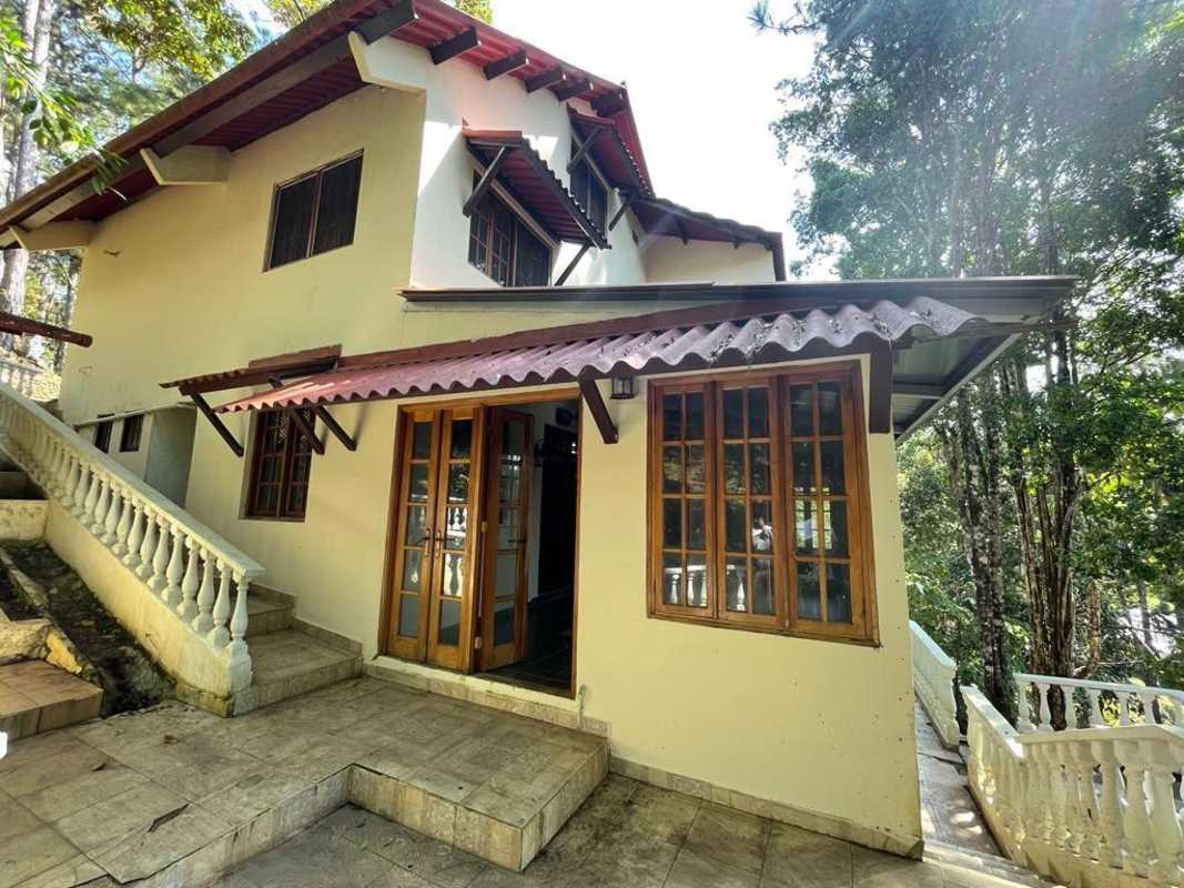 Rustic bedroom with wrought iron bed ceiling fan forest view in Altos de Cerro Azul