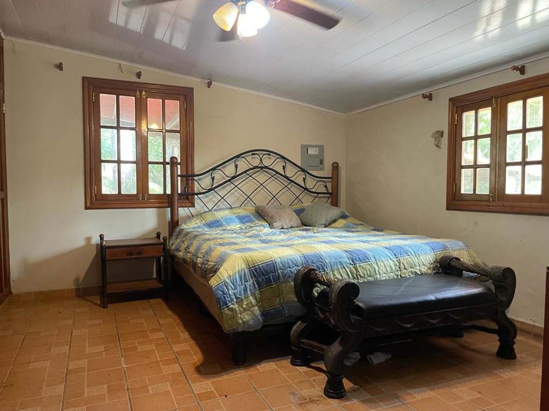 Traditional living room with sofas, fireplace, wooden beams in mountain house Altos de Cerro Azul