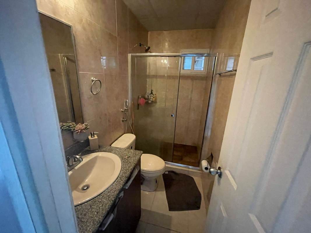 Bathroom with granite countertop, glass shower, tiled walls PH Monte Bello 24 de Diciembre Panama