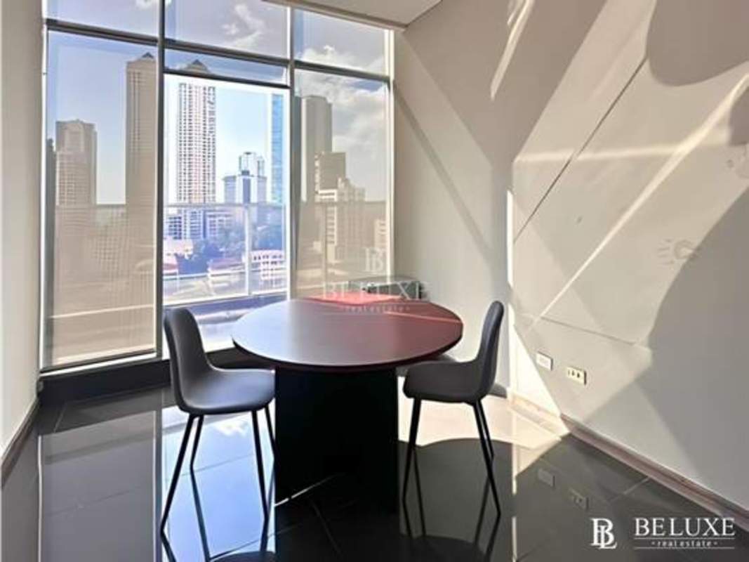 Bright furnished office space featuring panoramic floor-to-ceiling windows PH Habitats Panama City