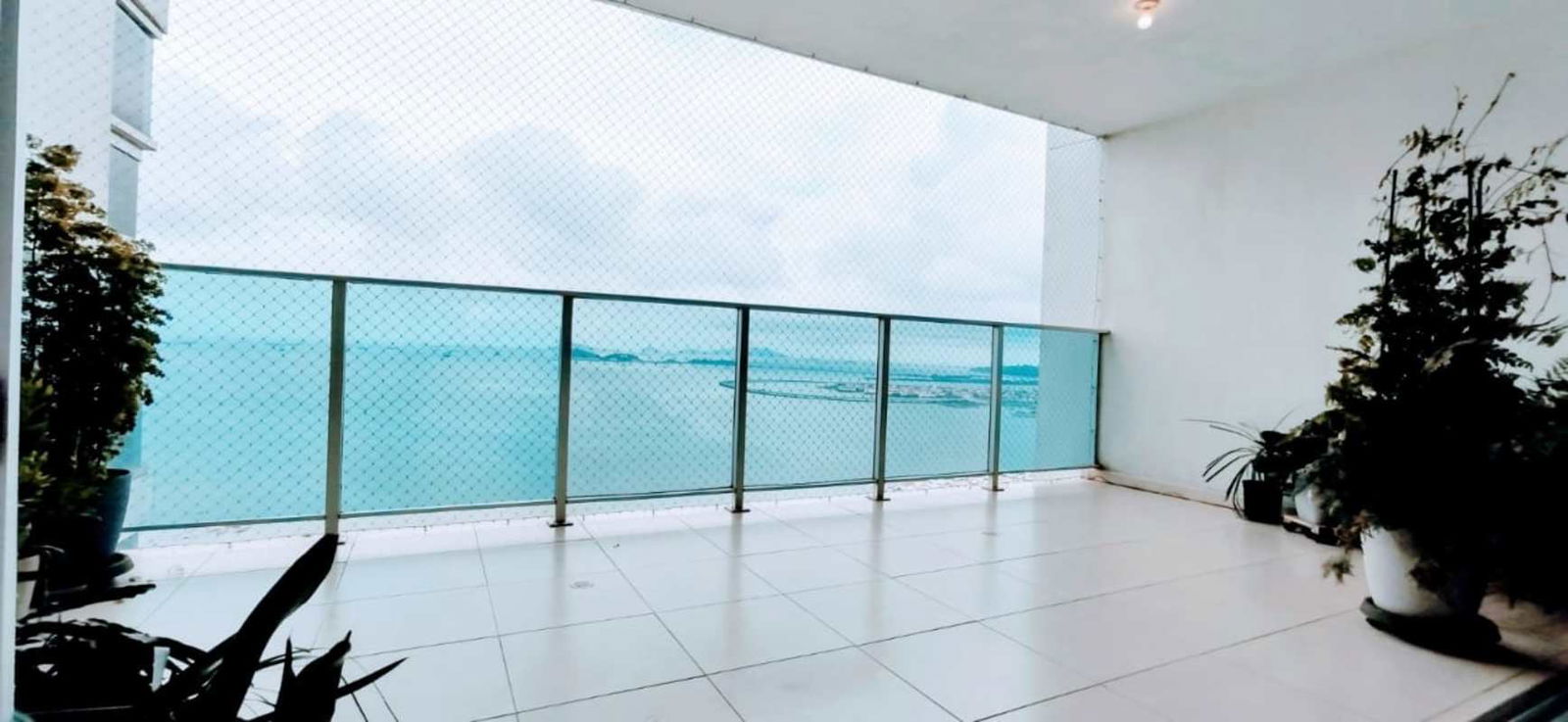 Panoramic balcony with ocean view glass railing coastal apartment Panama