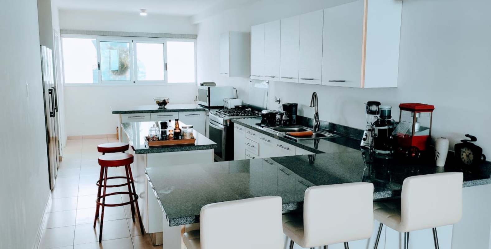 Open living dining room with panoramic windows in PH Waters On The Bay Panama