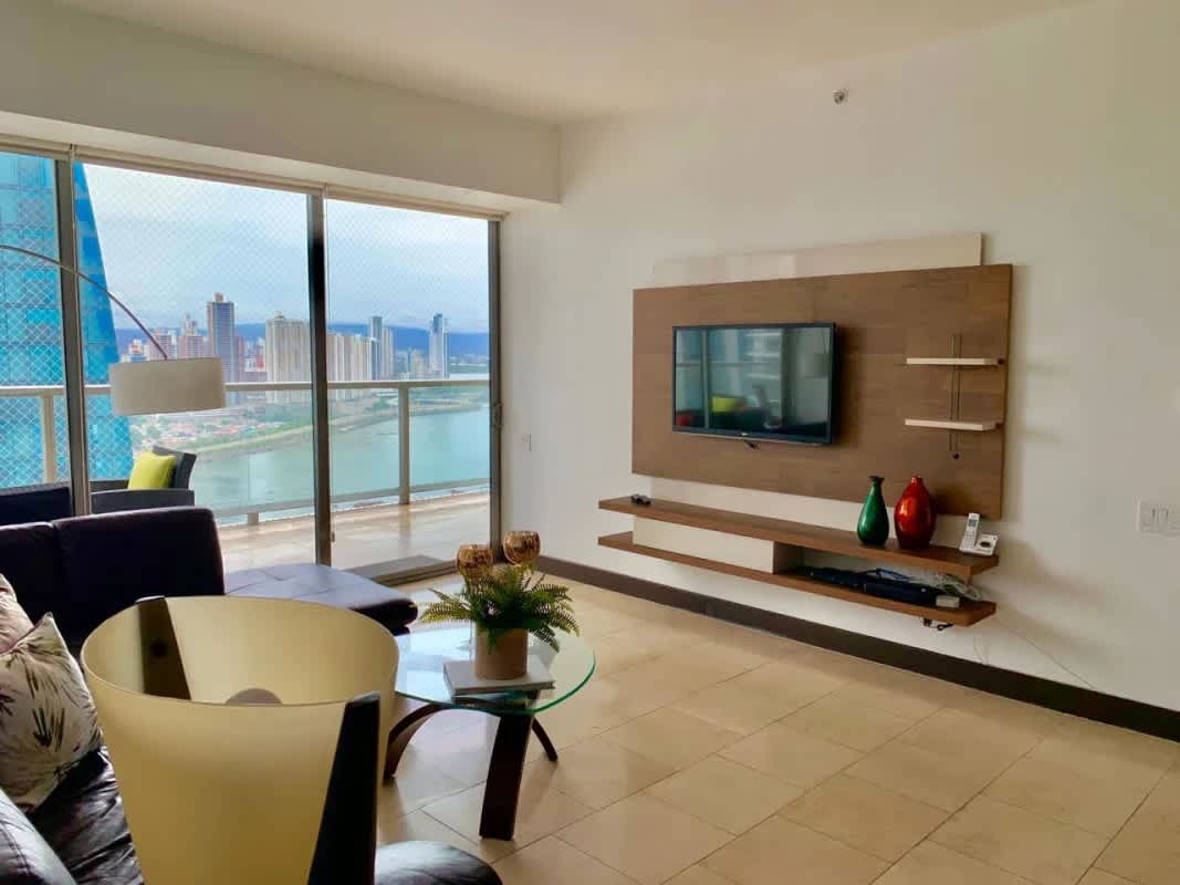 Modern living room with glass doors to balcony overlooking ocean at The Ocean Club Punta Pacífica