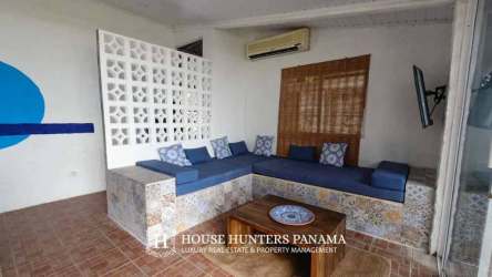 Mediterranean-style living room with built-in benches, rustic decor and air conditioning overlooking ocean