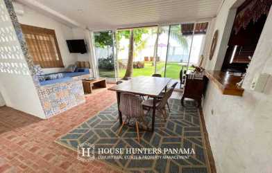 Bedroom with double beds, wooden ceiling, ocean terrace access at Playa Malibu Panama