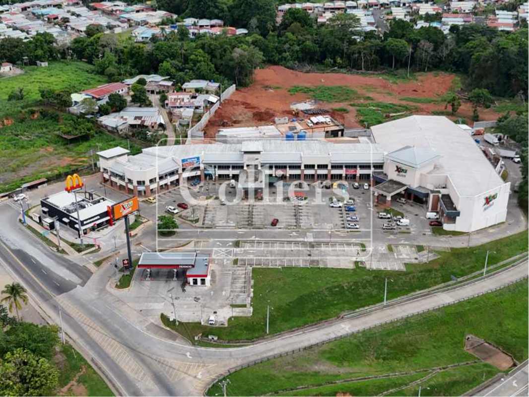 Aerial view of Plaza Villalobos shopping center retail stores gas station and parking Panama