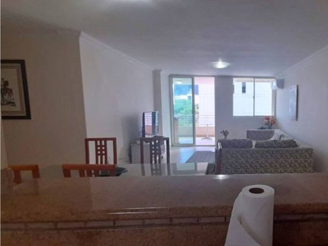 Living and dining area with balcony access in PH Sunrise Tower Obarrio Panama