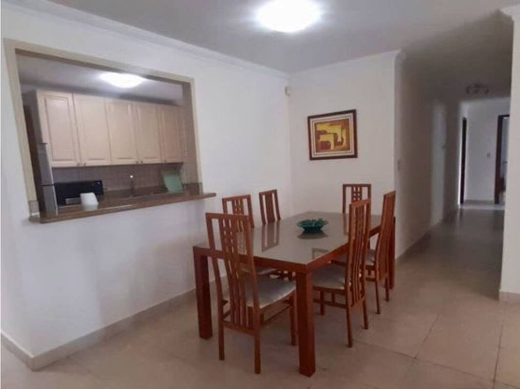 Contemporary dining room with glass-top table, pass-through kitchen in PH Sunrise Tower Obarrio