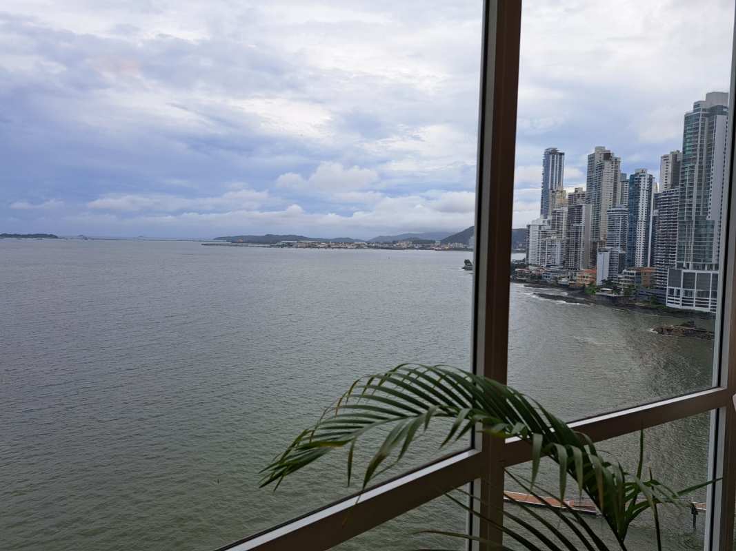 Inside luxury apartment with floor-to-ceiling windows offering stunning ocean and city skyline views Trump Ocean Club Panama