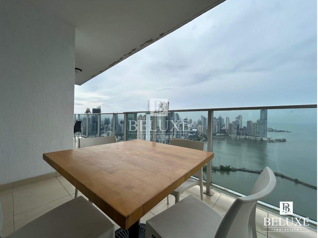 Large bedroom with floor-to-ceiling windows and ocean view balcony PH White Panama City
