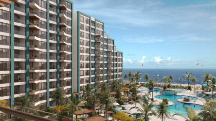 Bright tropical master bedroom with balcony and ocean views at Margaritaville Playa Caracol