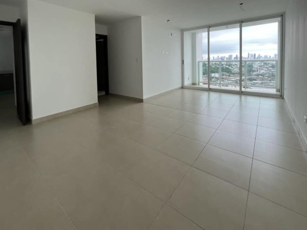 Modern kitchen with L-shaped wood cabinetry and large window at PH Kings Park Tower 500 Condado del Rey Panama