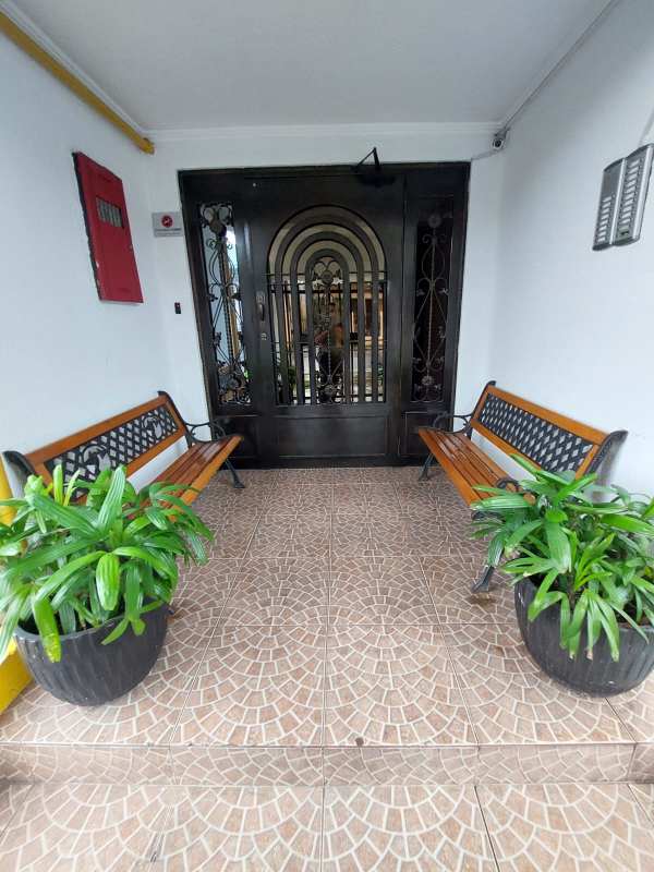 Secure entrance lobby of PH Girasoles with security gate seating area and plants